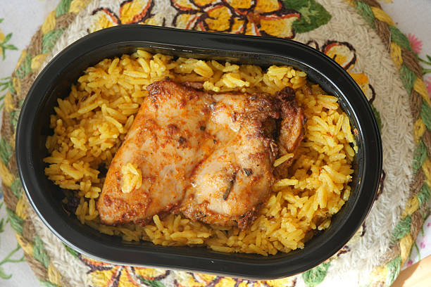 istock Savory chicken and yellow rice in a takeout container 2243354295