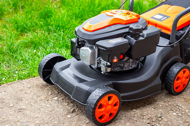 istock A close-up of a new, modern lawn mower, showing its engine and rugged construction 2243358517