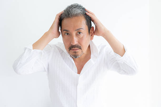 middle-aged man doing beauty care on a white background