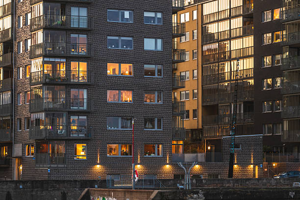 istock Modern apartment buildings with illuminated windows during blue hour.. 2243360082
