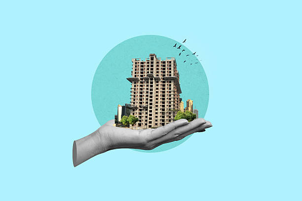 istock Hand holding modern building creative concept. Labor day concept. 2243360837