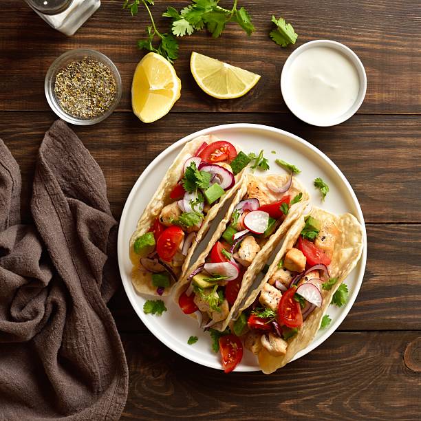 istock Tacos with vegetables and meat on wooden background 2243361099