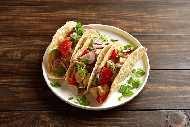 istock Tacos with vegetables and meat on wooden background 2243361101