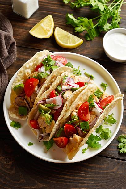 istock Tacos with vegetables and meat on wooden background 2243361108