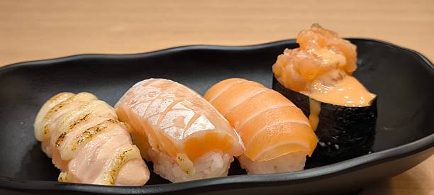 istock Sushi on a black plate on a wooden table 2243362881