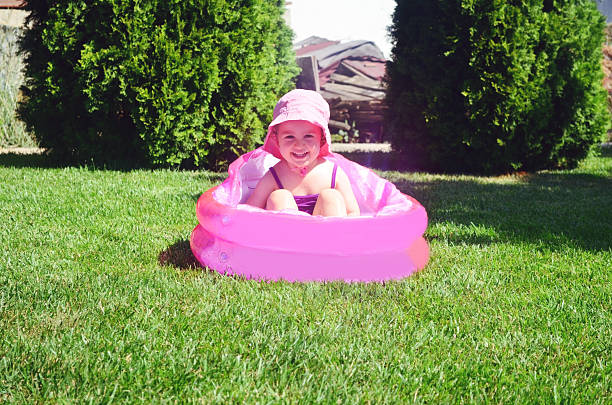 Children playing in inflatable baby pool.