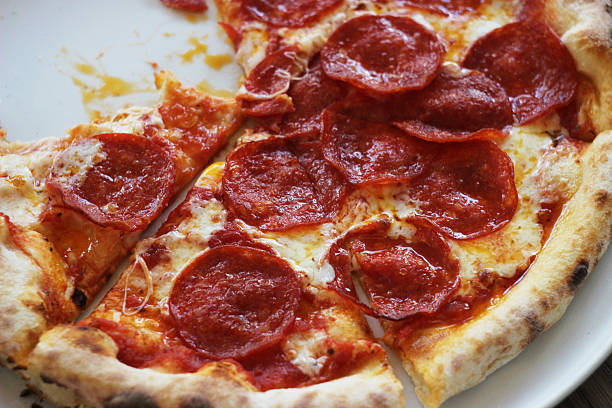 Hot pepperoni pizza in a plate on the table