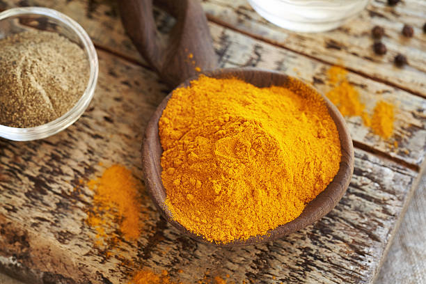 istock Dry turmeric root powder with ground black pepper in the background 2243370207