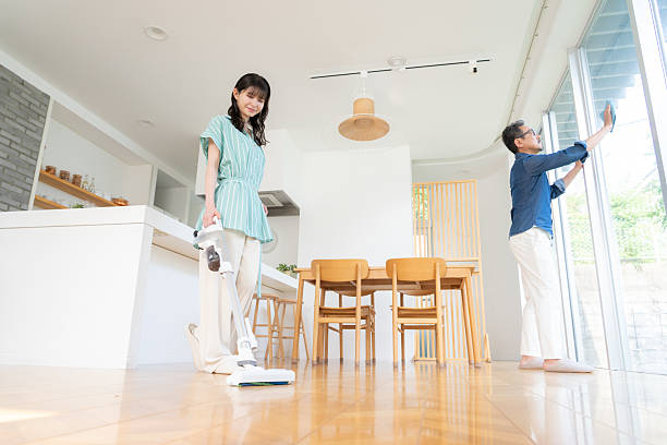 istock a middle-aged couple cleaning the loving room 2243375513