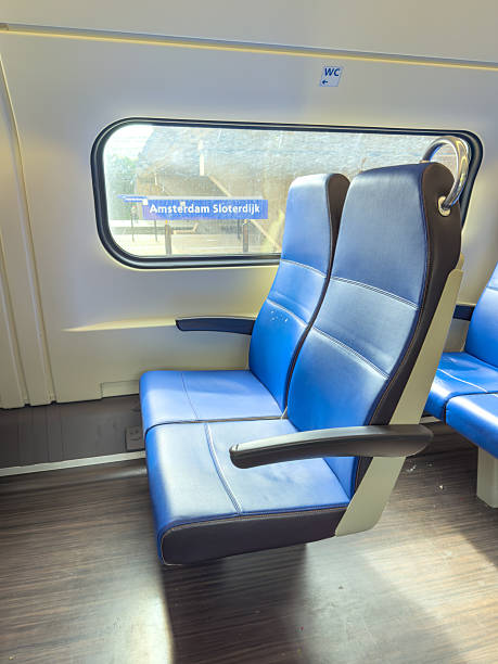 istock Interior of Dutch train with empty seats at Amsterdam Sloterdijk station 2243375742