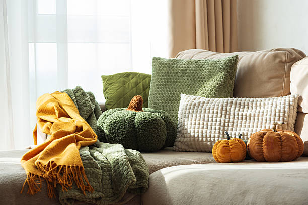 istock Autumn Sofa Styling with Textured Pillows, Fabric Pumpkins, and Cozy Blankets 2243375914