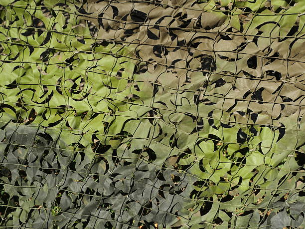istock Camouflage Net in Green Shades with Fabric Strips for Concealment 2243376315