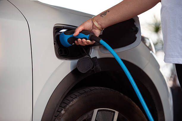 istock Charging Electric Vehicle at Home with Blue Cable. 2243377096
