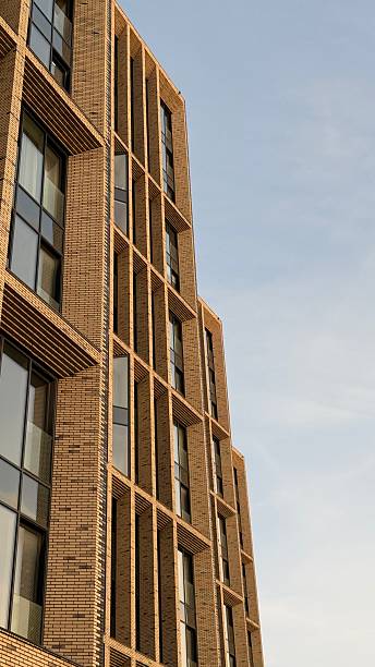 istock Modern brick building facade against clear blue sky, vertical architectural background 2243380288