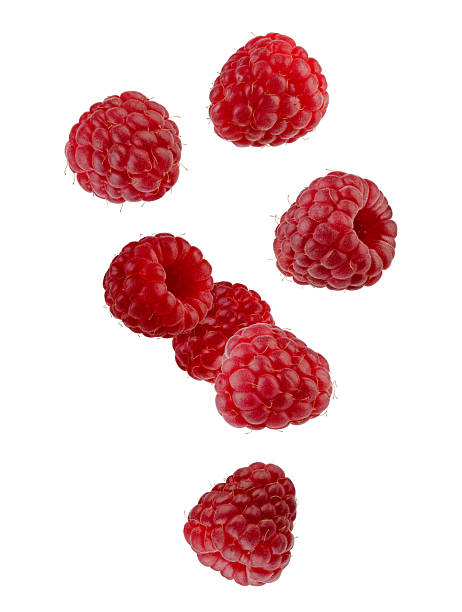 istock Beautifully retouched raspberries falling through space. Isolated on white. 2243380578