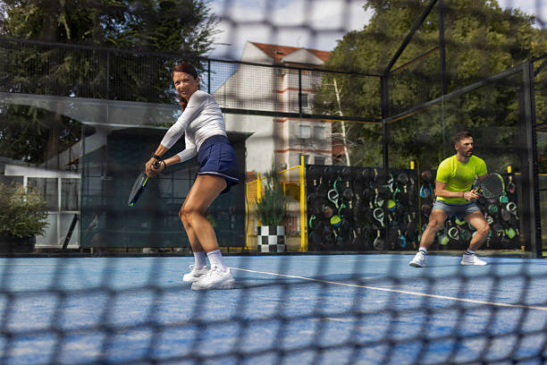 istock Sports Perspective: Padel Match Seen Through Court Net 2243380725