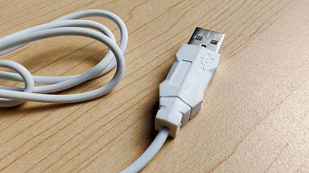 istock White USB-A Cable Plug and Coiled Cord on Wood Desk Surface 2243381131