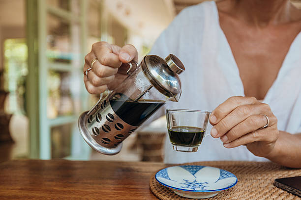 Pouring Fresh Coffee from French Press into Cup