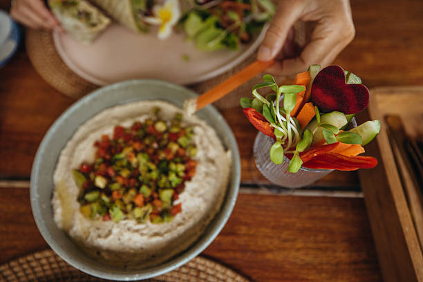 istock Fresh Vegetable Sticks Dipped in Hummus Bowl 2243383226