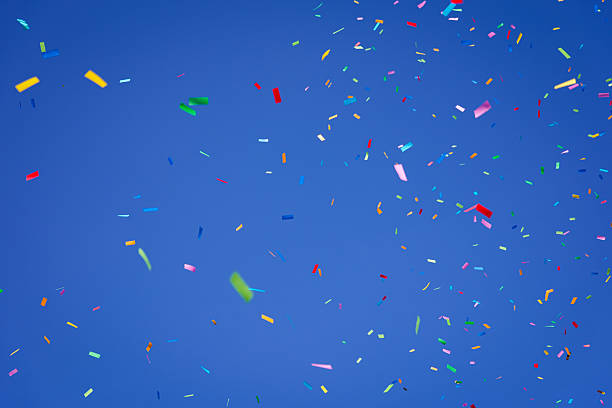 istock Vibrant Colorful Confetti Falling Against Blue Sky 2243384418