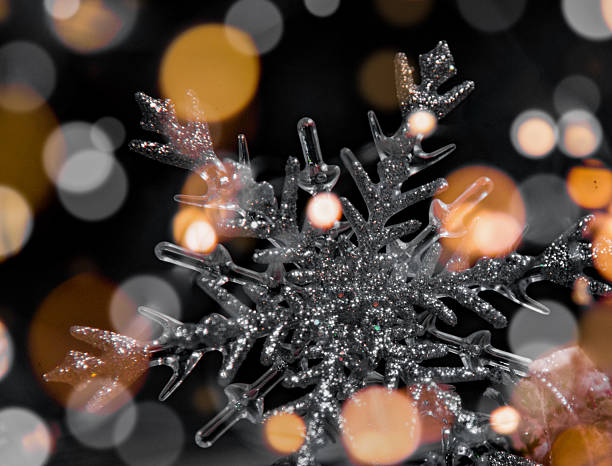 istock Glittering Snowflake with Warm Bokeh Lights — Abstract Winter Holiday Background 2243385458