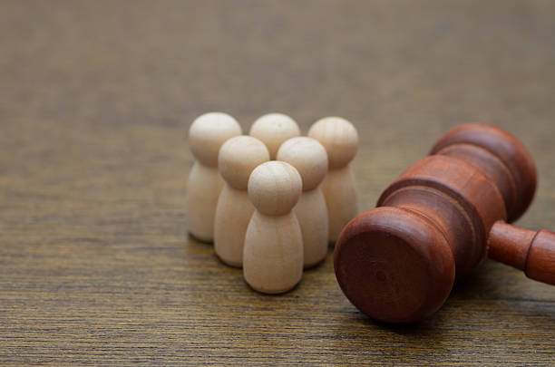 istock A group of figures observes a gavel, symbolizing class action, public hearings, or social justice. 2243387217