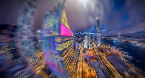 istock Hong Kong nightscape with a dramatic radial blur effect, emphasizing motion speed. Buildings are rendered with vibrant lights, creating a dynamic, blurred representation of the city. 2243387550