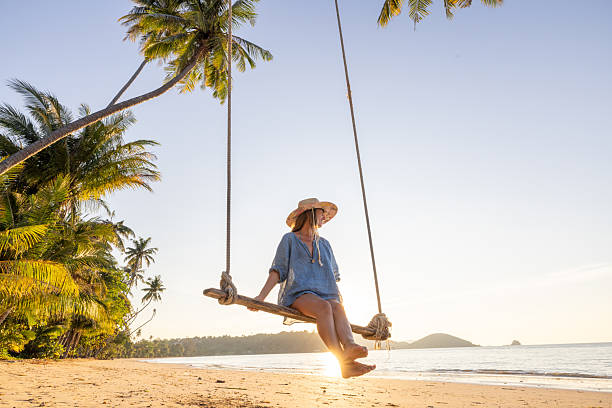 istock Woman Relaxing on Beach Swing at Sunset 2243387813
