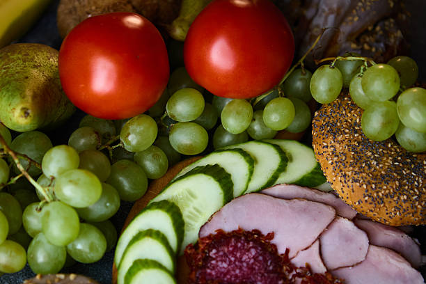 istock Culinary composition of ham salami tomatoes grapes and cinnamon buns 2243390174