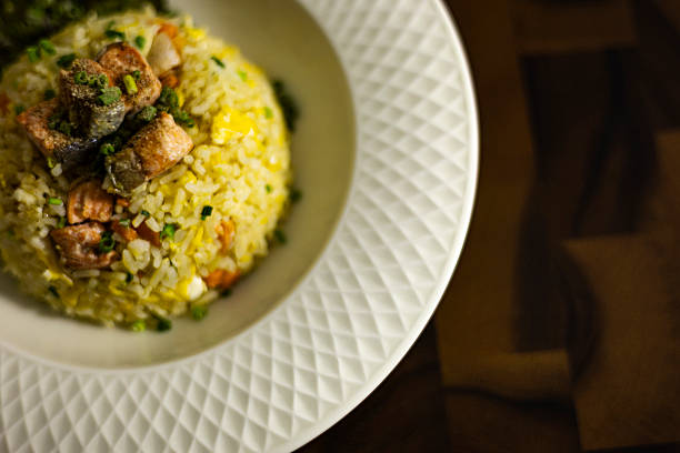 istock Plate Of Salmon Fried Rice On Rustic Wooden Table 2243390362