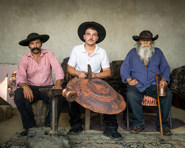 istock Three generations of roma coppersmiths from romania posing with their tools and an unfinished copper piece 2243390436