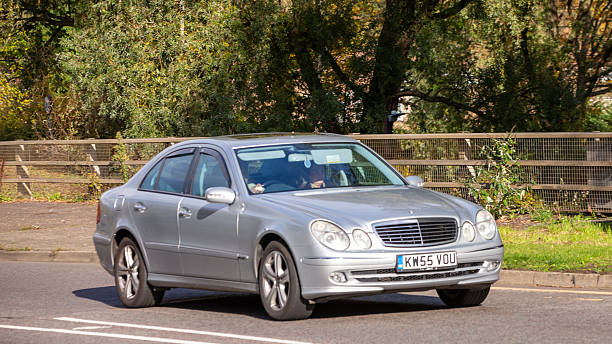 Milton Keynes,Bucks,UK - Oct. 26th 2025:  2006 silver Mercedes Benz e500 car driving on a British road