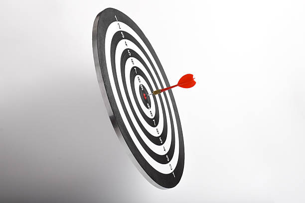 istock Dart arrow hitting in the target center dart board 2243391573