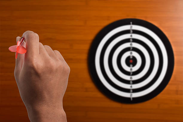 Man with arrow aiming at dart board. Target and goal as concept