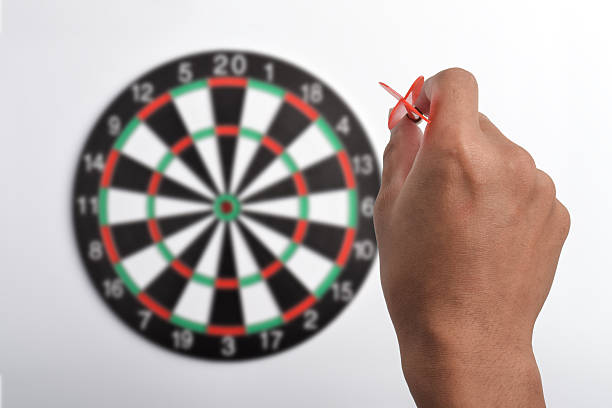 istock Man with arrow aiming at dart board 2243392729