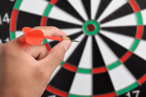 istock Close up hand holding dart aiming at target 2243392746
