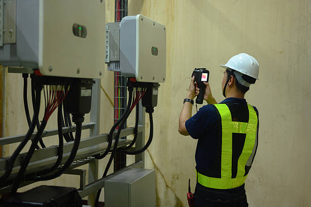 istock Male technician Check the solar inverter panels in the electrical room. Service engineer installs solar cells on factory roofs Clean energy and renewable energy concepts 2243393364