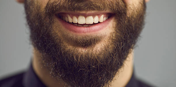 istock Confident bearded man white toothy smile close up studio face portrait 2243395641