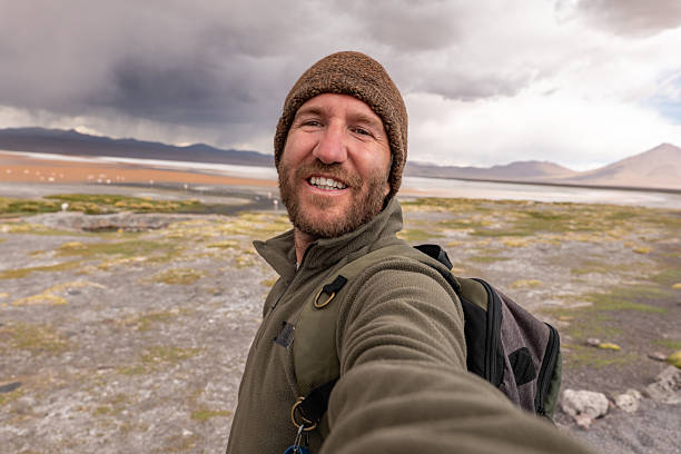 istock Smiling Man Taking Selfie on Mountain Hike 2243400613