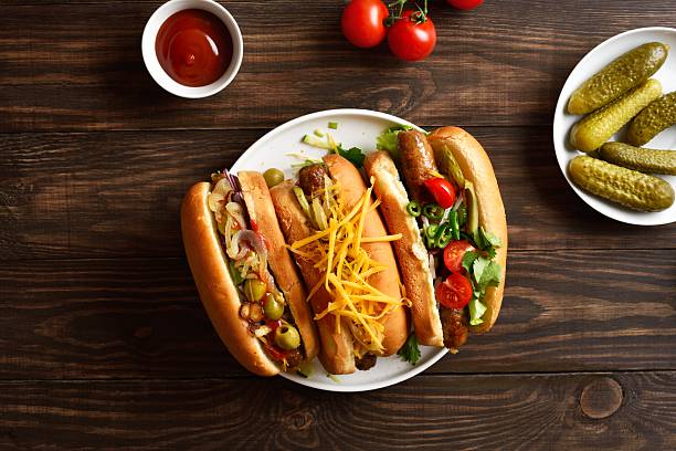 istock Hot dogs with different toppings on wooden background 2243402637