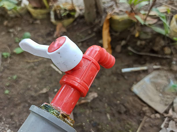 The water tap is turned off, and the pipe shows signs of rust and weathering, indicating it has been exposed to outdoor conditions for a long time.