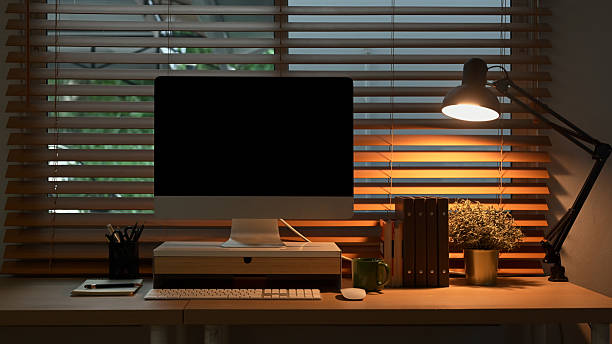 istock Computer on desk in peaceful nighttime workspace with office supplies 2243403999