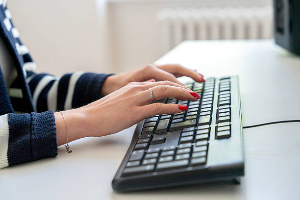 istock Hands typing on a keyboard in a modern office setting during the daytime 2243404395