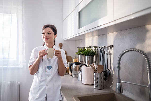 istock Healthcare professional having a coffee break in kitchen 2243404909
