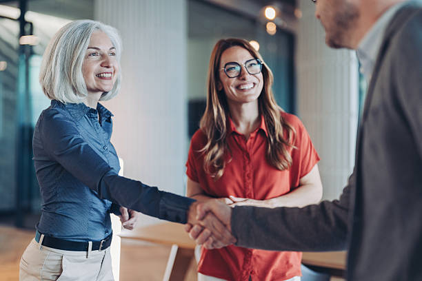 istock Smiling mature woman congratulating a colleague 2243407821