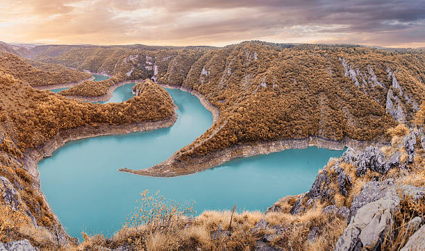 istock Uvac River forming breathtaking turquoise meanders, winding through a deep canyon with forested slopes in Serbia during autumn 2243412471
