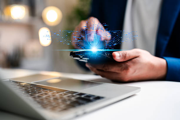 istock A businessman using mobile phone and laptop, secure access to user personal information, secure Internet access, information security encryption. Cybersecurity internet network data privacy concepts. 2243413756