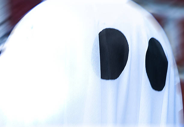Ghostly Halloween figures outside a house