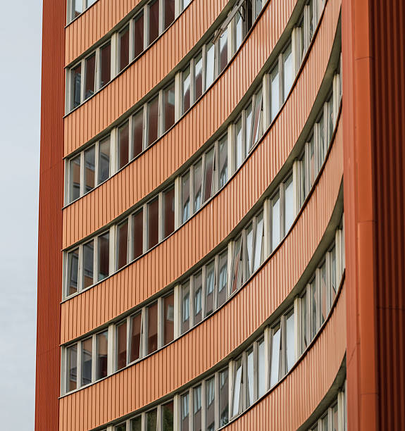 istock Curved orange highrise building with many windows.. 2243418391
