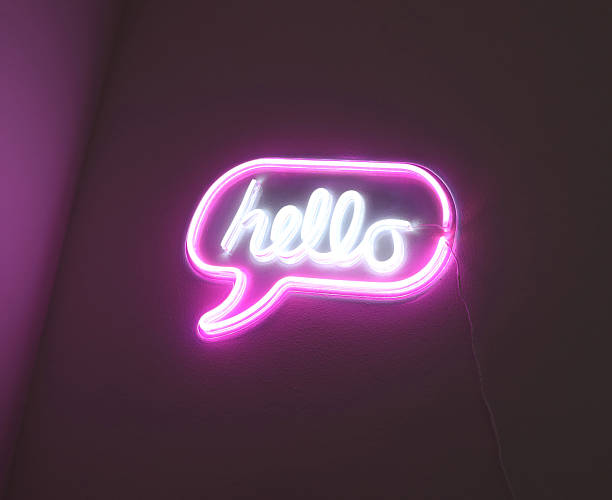istock Pink neon speech bubble sign saying hello glowing 2243419018